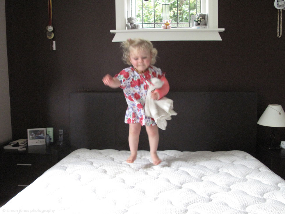 Little Grace jumping on the bed